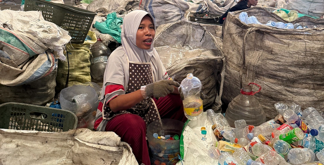 Waste workers in sorting facility